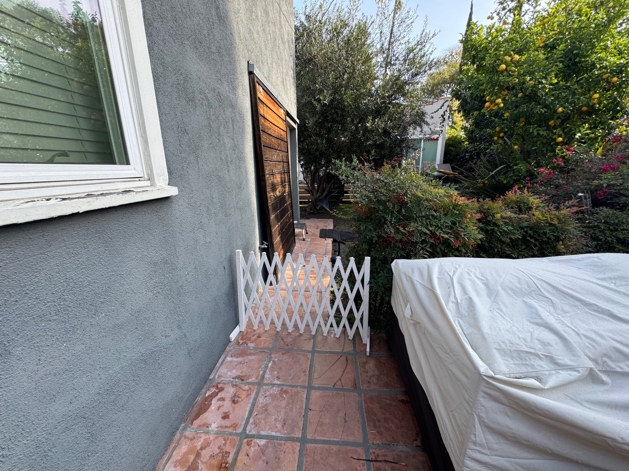 December 2025 photograph showing a small white lattice gate installed where the privacy barrier had been removed
