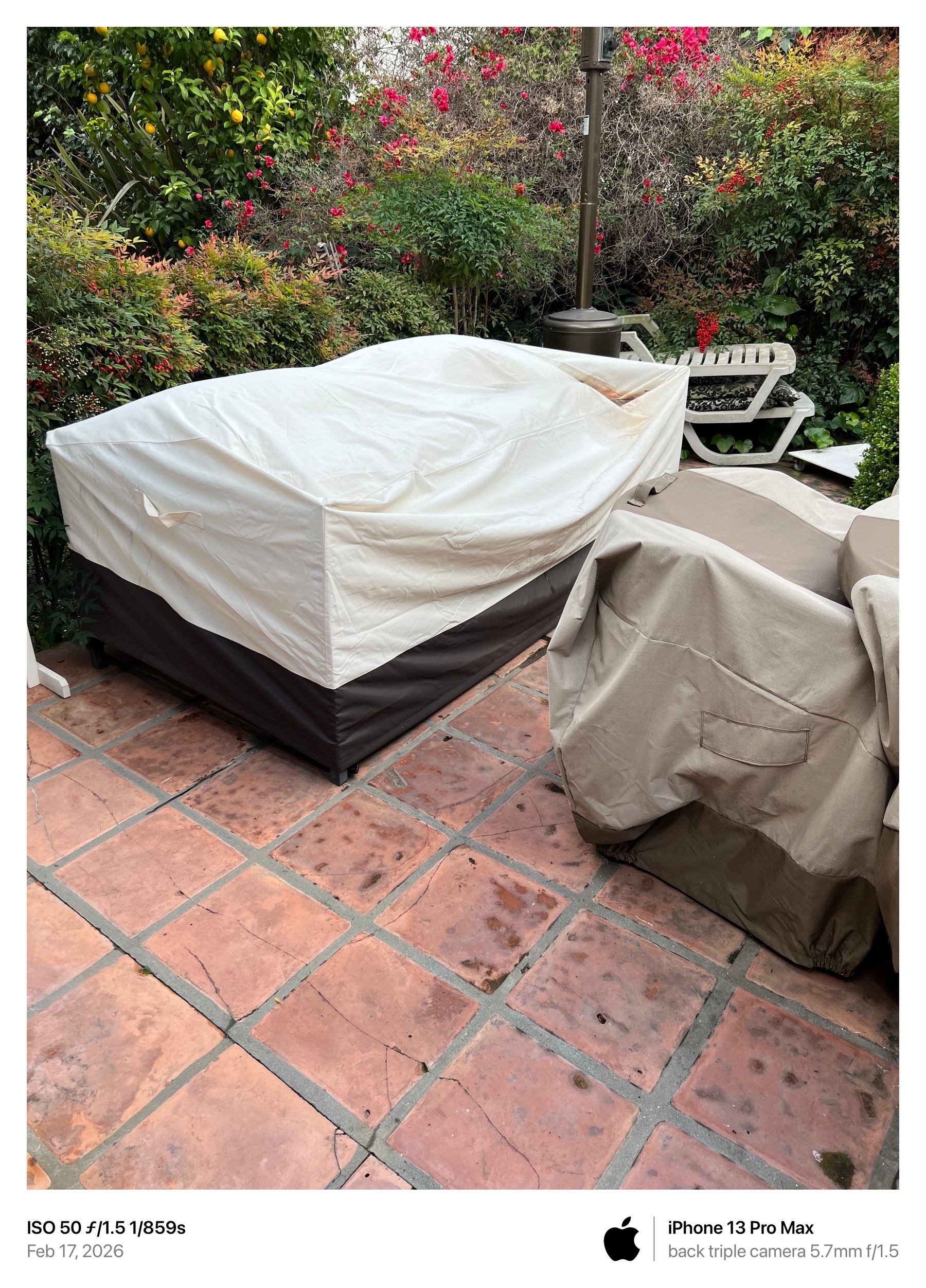 February 17, 2026 photograph showing visibly soiled patio tiles and outdoor furniture